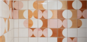 Smink Studio screen-printed tiles in blush, peach and burnt orange half-circles on white glazed ceramic tiles.