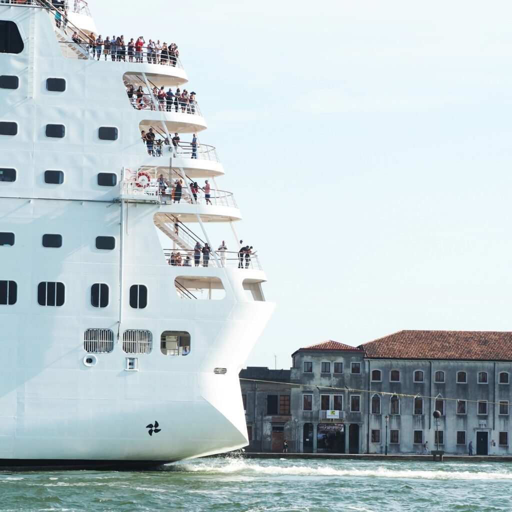 Cruise ship passing historic buildings on the Venice waterfront.