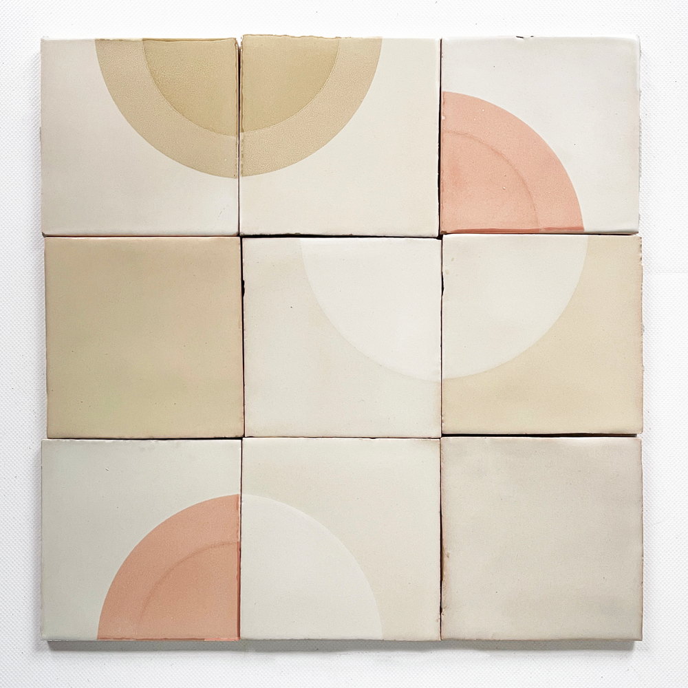 Nine Smink Studio tiles in white and cream, screen-printed tone on tone so the half-circles are only just visible against the base glaze.